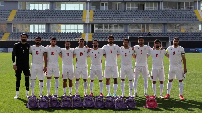 Iran football team protests schoolgirl killings with armbands, bags