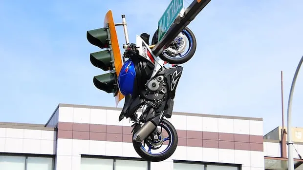Motorcyclist hurt, bike dangling from traffic light in Delta