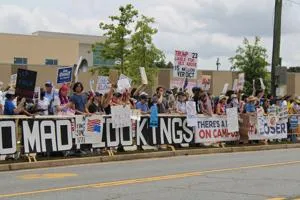 Protesters Greet Trump with 'No Kings' Signs in East Cobb